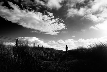 Poster - A black and white image of a hiker exploring the English Countryside, Muggleswick Common near Edmundbyers, England UK.