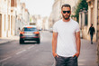 © 4Max - Hipster handsome male model with beard wearing white blank t-shirt with space for your logo or design in casual urban style