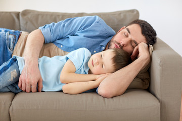 Poster - happy father and son sleeping on sofa at home