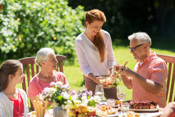 Wall Mural - happy family having dinner or summer garden party