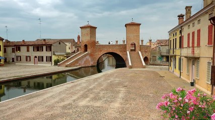 Sticker - panning shot of a rare three way bridge in picturesque lagoon village in Italy, color graded clip