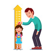 Teacher or father measuring girl kid height