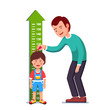 Teacher or father measuring boy kid height