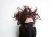 © Deana - Dark haired female covering her face with her hands with her hair out around her.