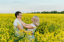 Young Couple In A Yellow Field