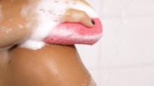 Happy Woman Washing Herself With Sponge And Soap In Shower Slow Motion Closeup
