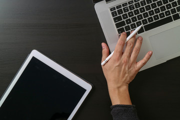 Poster - cyber security internet and networking concept.Businessman hand working with laptop computer and digital tablet