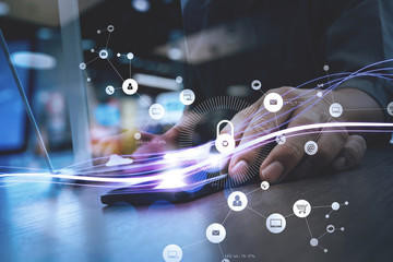 Poster - cyber security internet and networking concept.Businessman hand working with VR screen padlock icon on mobile phone and laptop computer background