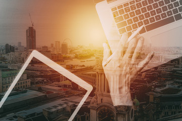 Poster - cyber security internet and networking concept.Businessman hand working with laptop computer and digital tablet with buildings exposure