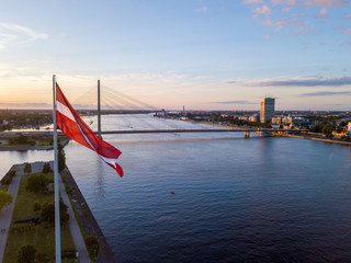 Beautiful aerial sunset view over AB dam in Riga Latvia with a huge Latvian flag