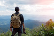 © doidam10 - Man Traveler with photo camera and backpack hiking outdoor Travel Lifestyle and Adventure concept.