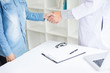 © snowing12 - Doctor shakes hands at medical office with patient, wearing glasses, stethoscope and lab coat.