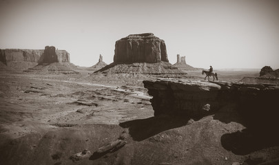 Poster - Cowboy on a horse on the background of the Valley of Monuments