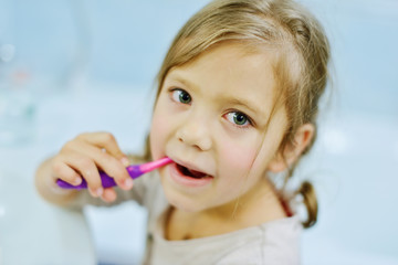 Wall Mural - Little girl brushing teeth