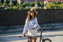 Woman With Bicycle On Street