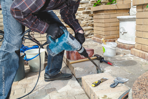 Fotografie, Obraz Construction Hammer destroying brickwork