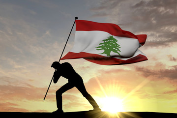 Wall Mural - Lebanon flag being pushed into the ground by a male silhouette. 3D Rendering
