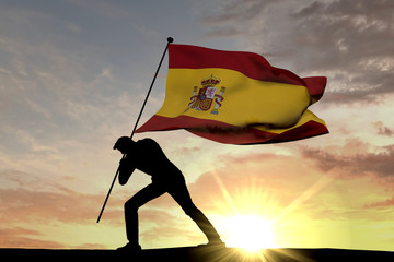 Wall Mural - Spain flag being pushed into the ground by a male silhouette. 3D Rendering