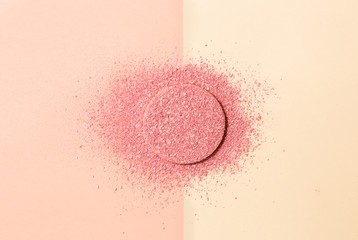 Powdered blush on a sponge on double background of pink and beige