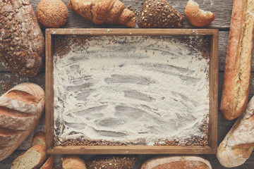 Wall Mural - Bread bakery background. Brown and white wheat grain loaves comp