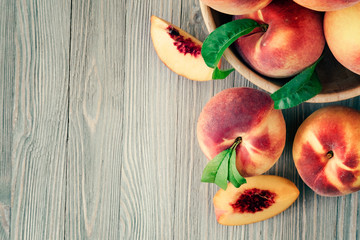 Poster - Peaches on wooden background with copy space