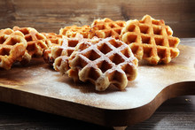 Traditional Belgian Waffles On Brown Wooden Board