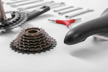 Bicycle parts and repair tools on white background