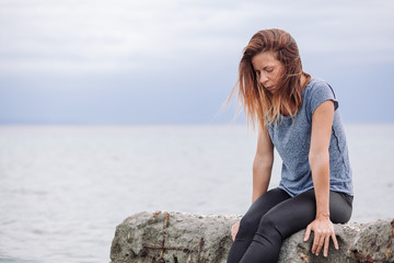 Woman alone and depressed at seaside