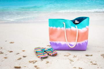 Sticker - Bag and flip-flops on sea beach. Summer vacation concept