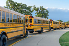 School Bus Line In Parking Lot Of High School