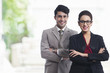 © IndiaPix - Portrait of smiling business colleagues standing arms crosses in office