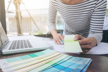 Poster - Creative creativity graphic designer working with graphics tablet,laptop and smart phone, colour chart at workplace on wooden desk , colour ideas style concept