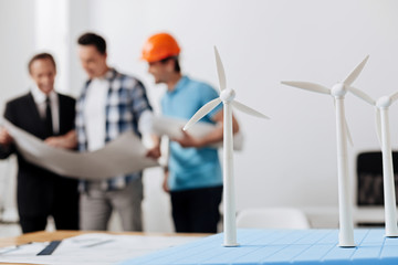 Wall Mural - Group of workers looking through a blueprint