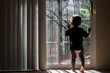 © Leslie Kershaw - toddler  faces window to outdoors