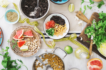 Tape measuring with variety healthy food on wooden table