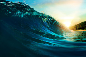 Fototapete - rough colored ocean wave falling down at sunset time