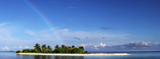 Wall Mural - merged panoramic image. tropical maldivian island in daylight with rainbow on horizon and white sand