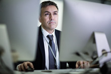 Businessman Using Computer Late At Night