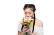 © LIGHTFIELD STUDIOS - beautiful asian girl with closed eyes smelling flowers isolated on white
