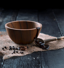 a wooden cup and spoon with layer of chocolate and chips