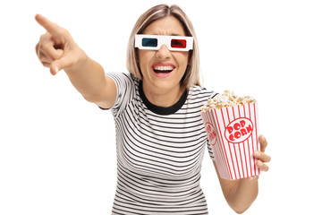 Sticker - Young woman with 3D glasses and popcorn pointing and laughing