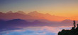 Himalaya mountains at dawn, with fog and clouds. Natural background, blurred. Horizontal panoramic view.