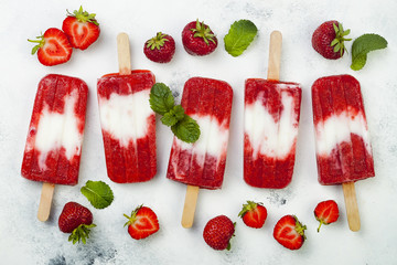 Poster - Homemade vegan strawberry coconut milk popsicles - ice pops - paletas on rustic white background