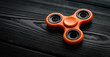 close up orange spinner on a black background