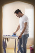 © IndiaPix - Young man ironing his shirt in room