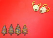 © TANIDA - Deer head chocolate cookies and christmas tree berry cookies on red plastic background have space for put text