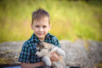 the boy with husky puppy