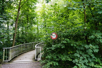 do not pass stop sign in front of a bridge overgrown