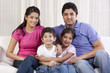 © IndiaPix - Portrait of happy family sitting on sofa