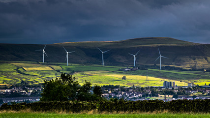 Wind turnbines on the hill with blue clouds